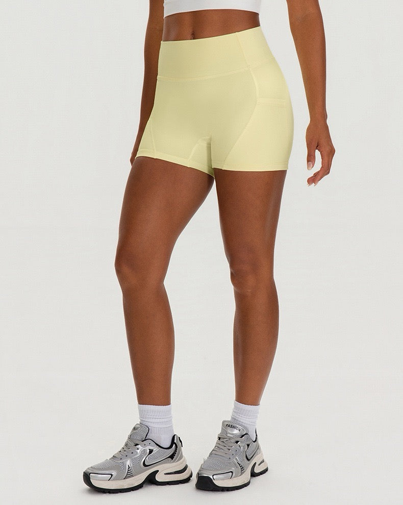 yellow slim fitting high waist active shorts for women